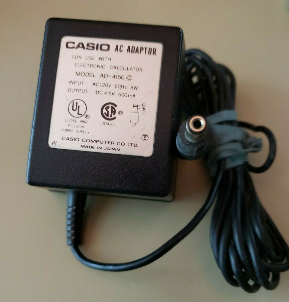 Casio AC Adapter For Electronic Calculator # AD-4150 Output : 4.5V DC 600m Features: Powered Connector B: nil MPN: A